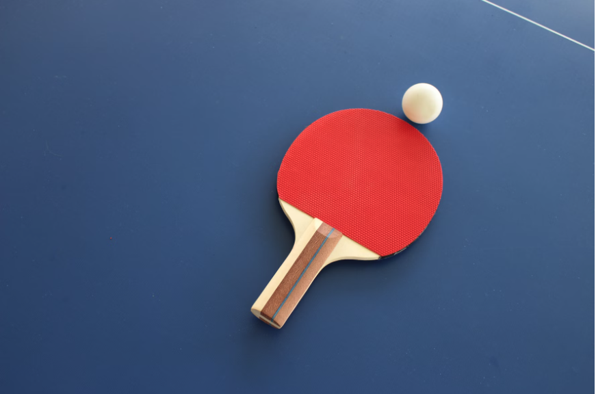 table tennis bat and ball on a table